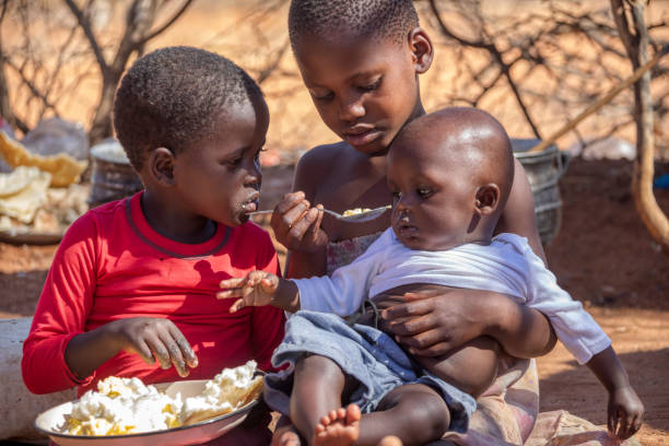 Photo of three African children sharing a meal in the ASALs