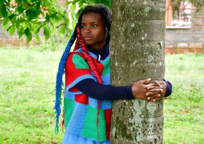 Truphena Muthoni hugging a tree during the 72-hour tree hugging feat